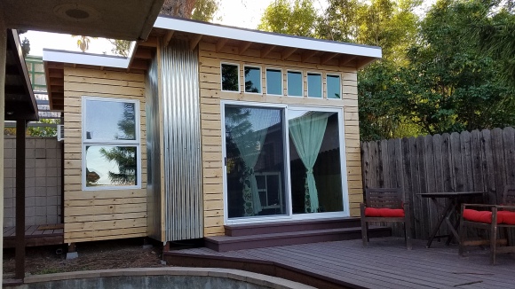 Mark in L.A. took the concept up a notch by adding a small extension to the side and thereby expanding the space, and complimenting the design. I love the clean, light lines of the siding boards and the use of vertical roofing panels for siding accents.